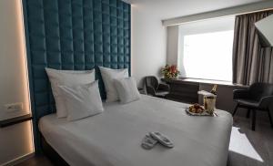 Postel nebo postele na pokoji v ubytování De Keyser Hotel