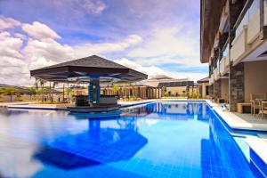 a pool at a hotel with a blue pool at Cebu Westown Lagoon - South Wing in Cebu City