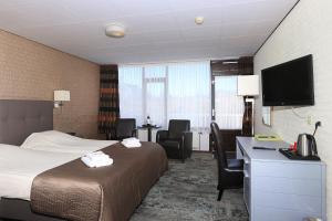 Postel nebo postele na pokoji v ubytování Hotel Cafe Restaurant Duinzicht