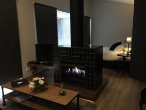 a living room with a fireplace and a bed at Indulge at Daylesford in Daylesford