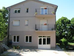 a house with two balconies and two doors at Apartman Belići in Kastav