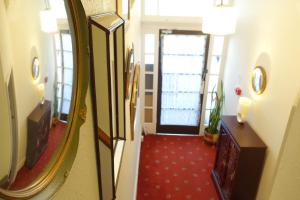 a hallway with a mirror and a red carpet at The Hutchinson Apartments in Douglas