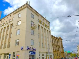 a large yellow building with a sign on it at Apartment Olomouc Centre in Olomouc