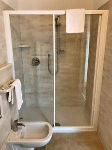 a shower with a glass door in a bathroom at La Lanterna in Garda