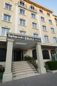 a hotel with a sign in front of a building at Topkapi Inter Istanbul Hotel in Istanbul