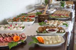 a buffet with many plates of food on a table at Montenero Resort&Spa in Czarna Góra