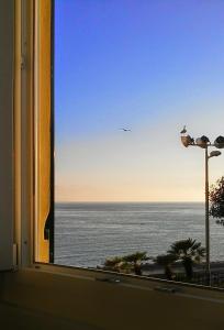 a view of the ocean from a window at Al Piccolo Scoglio - Room & Breakfast in Camogli