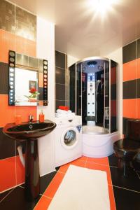 a bathroom with a washing machine and a sink at PaulMarie Apartments on Zaslonova 4 in Soligorsk