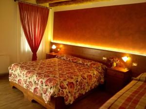 a bedroom with two beds and a red curtain at Al Filò in Marostica