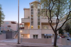 an apartment building with a balcony on a street at Urban Chic LUXE apartments near Beach Bačvice & CENTRE in Split +7 photos