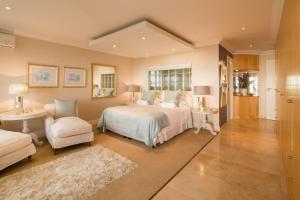A bed or beds in a room at Atlantique Villa Camps Bay 4-Bedroom Luxury Villa
