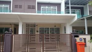 a house with a wooden fence in front of it at Ila Homestay in Senawang