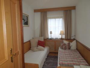 a hotel room with a couch and a window at Ferienwohnung Eder in Hippach