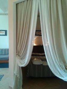A bed or beds in a room at La Vela - Dimora d'Epoca- Appartamenti