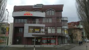 a tall apartment building with a sign on it at Hotel Africa in Haskovo