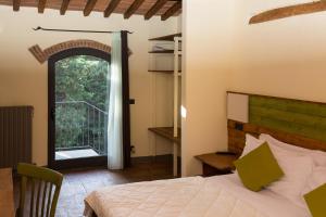 a bedroom with a bed and a large window at Florence Country Relais in Fiesole