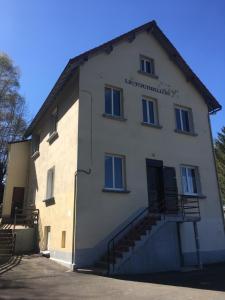 a large building with stairs on the side of it at Le tourbillon in La Bourboule