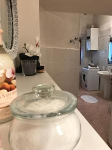 a glass jar on a counter in a kitchen at Claves Claustri - Appartamento storico con balcone in Sarteano +33 photos