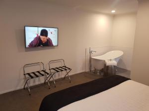 A television and/or entertainment center at Trendy Bungalow in the Heart of Rotorua