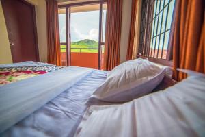 Postel nebo postele na pokoji v ubytování Mist Resorts Ooty