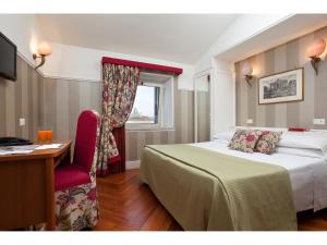 Postel nebo postele na pokoji v ubytování Hotel Kennedy