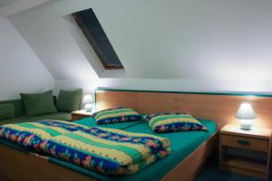 a bedroom with a bed and a couch at Dziwnów Wczasowisko in Dziwnów
