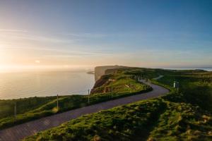 a path on a hill next to a body of water at Haus Sabina in Helgoland