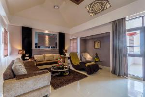 a living room with a couch and two chairs at Regenta Resort Bhuj by Royal Orchid Hotels Limited in Bhuj