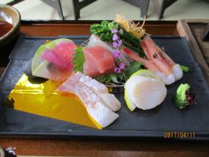 une assiette de nourriture avec des sushis et des légumes sur une table dans l'établissement Miharaso, à Toyooka