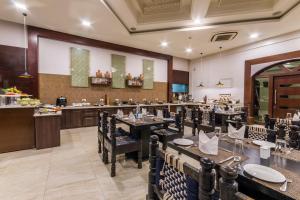 a restaurant with tables and chairs and a bar at Regenta Resort Bhuj by Royal Orchid Hotels Limited in Bhuj