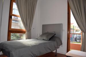 a bedroom with a bed and a large window at Apartamento San Isidro in La Orotava