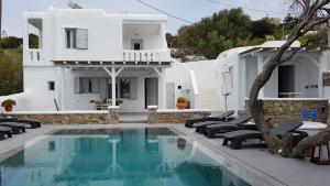 a villa with a swimming pool in front of a house at Villa Varnali Small Boutique in Mýkonos City