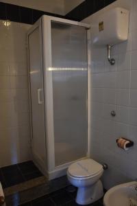 a bathroom with a shower with a toilet and a sink at Hotel La Tripergola in Pozzuoli
