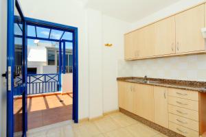 cocina con puerta que da a un balcón en Top Charco San Gines Stunning View Lanzarote By PVL, en Arrecife