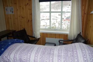 a bedroom with a bed and a window at Lunheim in Geiranger in Geiranger