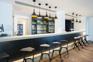 a bar with a row of stools at ibis Styles Kortrijk Expo in Kortrijk