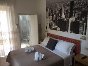 a bedroom with a large bed with towels on it at Hotel Monti in Riccione +54 photos