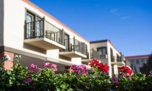 a building with balconies and flowers in front of it at Inn of the Governors in Santa Fe