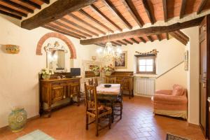 a living room with a table and a chair at CASA DI CHIARILU' in Cortona