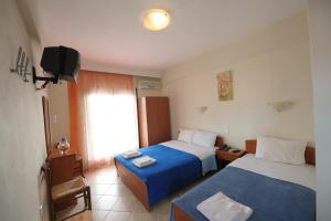 A bed or beds in a room at Panorama Spa Hotel