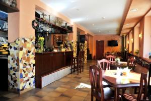 a restaurant with a table and chairs and a bar at Pakrantė in Klaipėda
