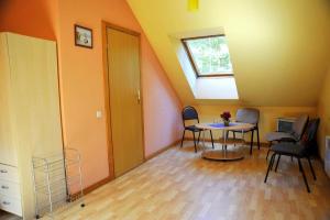 a room with a table and chairs and a window at Pakrantė in Klaipėda