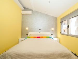 a bedroom with a large bed in a room with yellow walls at Apartments Princess View in Sveti Stefan