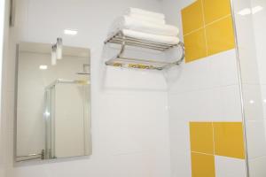 a bathroom with a towel rack and a mirror at Bracara Guest House "Bom Jesus" in Braga