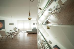 a living room and dining room with white walls at Bracara Guest House "Bom Jesus" in Braga