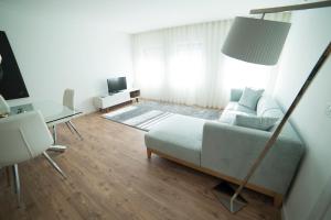 a living room with a bed and a table at Bracara Guest House "Bom Jesus" in Braga
