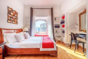 a bedroom with a bed with a desk and a window at HT N°9 Colosseo in Rome