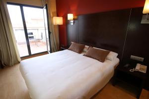 Postel nebo postele na pokoji v ubytování Hotel Alda Cardeña