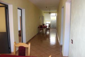 a hallway of a house with a table and chairs at Haka Guesthouse in Golem