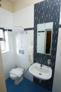 a bathroom with a sink and a toilet at Maria Giovanna Guest House in Marsalforn